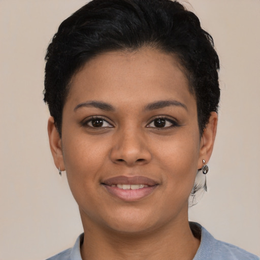 Joyful latino young-adult female with short  black hair and brown eyes