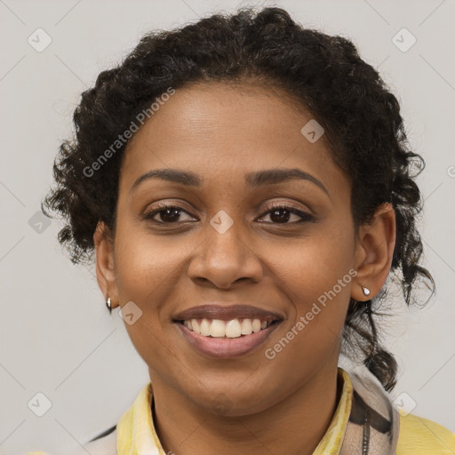 Joyful black young-adult female with short  brown hair and brown eyes