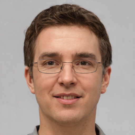 Joyful white adult male with short  brown hair and grey eyes