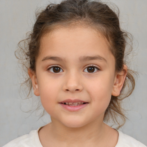 Joyful white child female with medium  brown hair and brown eyes