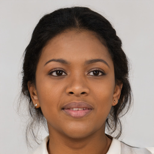 Joyful black young-adult female with medium  brown hair and brown eyes