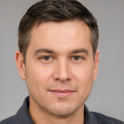 Joyful white adult male with short  brown hair and brown eyes