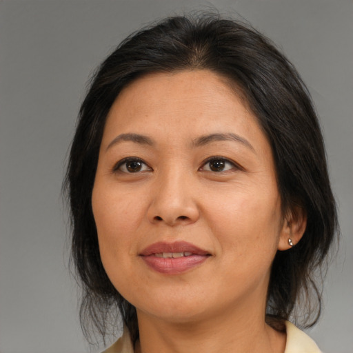 Joyful asian adult female with medium  brown hair and brown eyes