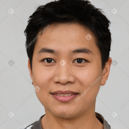 Joyful asian young-adult male with short  black hair and brown eyes