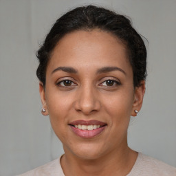 Joyful latino young-adult female with short  brown hair and brown eyes