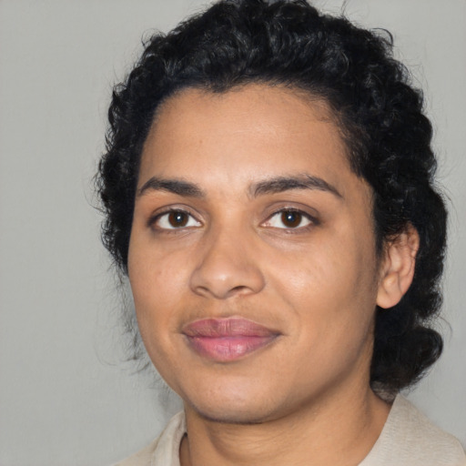 Joyful latino young-adult female with short  black hair and brown eyes