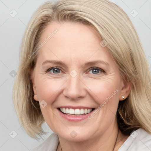 Joyful white adult female with medium  brown hair and blue eyes