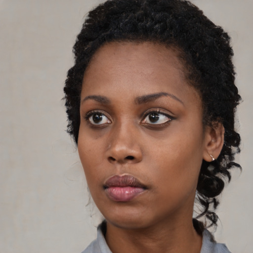 Neutral black young-adult female with medium  black hair and brown eyes
