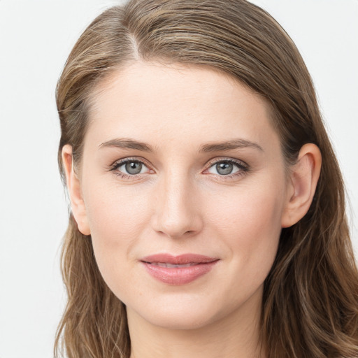 Joyful white young-adult female with long  brown hair and blue eyes