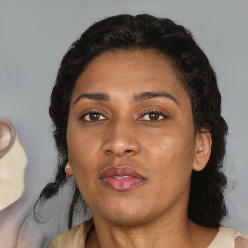 Joyful latino adult female with medium  black hair and brown eyes