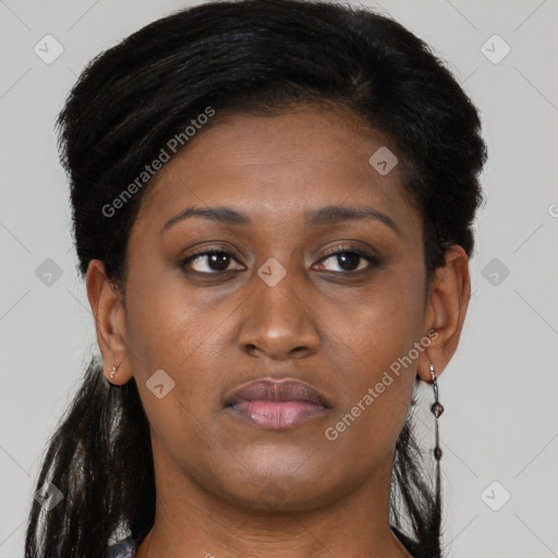 Joyful black adult female with long  brown hair and brown eyes