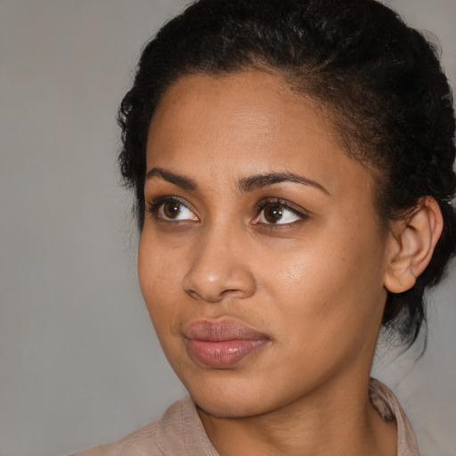 Neutral black young-adult female with medium  brown hair and brown eyes