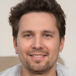 Joyful white adult male with short  brown hair and brown eyes