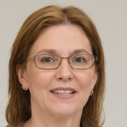 Joyful white adult female with long  brown hair and blue eyes