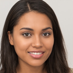 Joyful latino young-adult female with long  brown hair and brown eyes