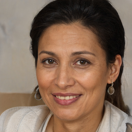 Joyful white adult female with medium  brown hair and brown eyes