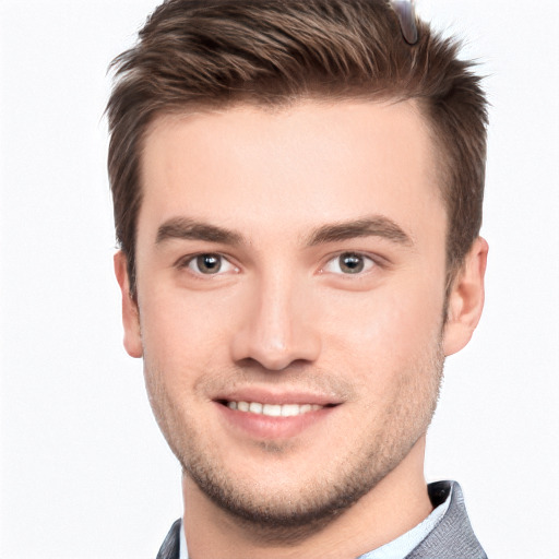 Joyful white young-adult male with short  brown hair and brown eyes