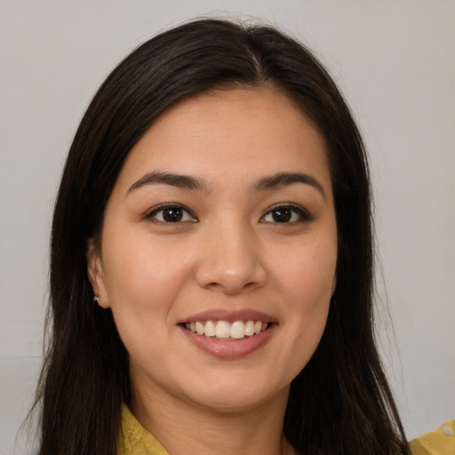 Joyful latino young-adult female with long  brown hair and brown eyes