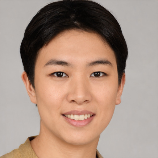 Joyful asian young-adult female with short  brown hair and brown eyes
