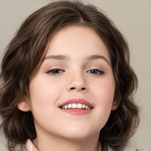 Joyful white child female with medium  brown hair and brown eyes