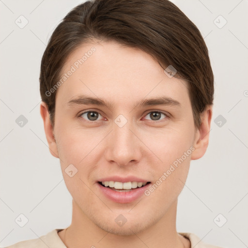 Joyful white young-adult male with short  brown hair and grey eyes