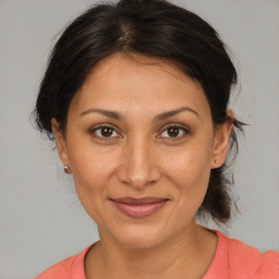 Joyful white adult female with medium  brown hair and brown eyes