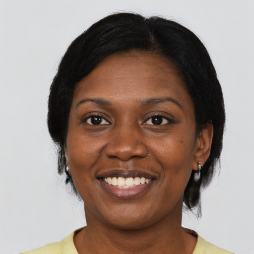 Joyful black young-adult female with medium  black hair and brown eyes