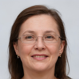 Joyful white adult female with long  brown hair and grey eyes