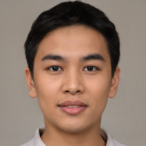 Joyful asian young-adult male with short  black hair and brown eyes