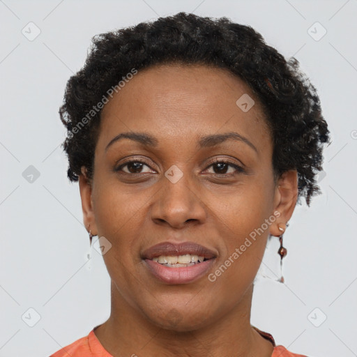Joyful black adult female with short  brown hair and brown eyes