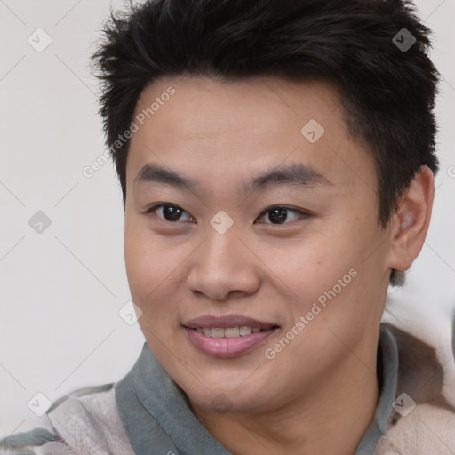 Joyful asian young-adult male with short  brown hair and brown eyes