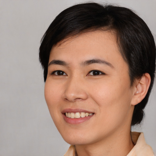 Joyful asian young-adult female with medium  black hair and brown eyes