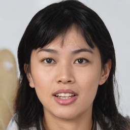 Joyful asian young-adult female with medium  black hair and brown eyes