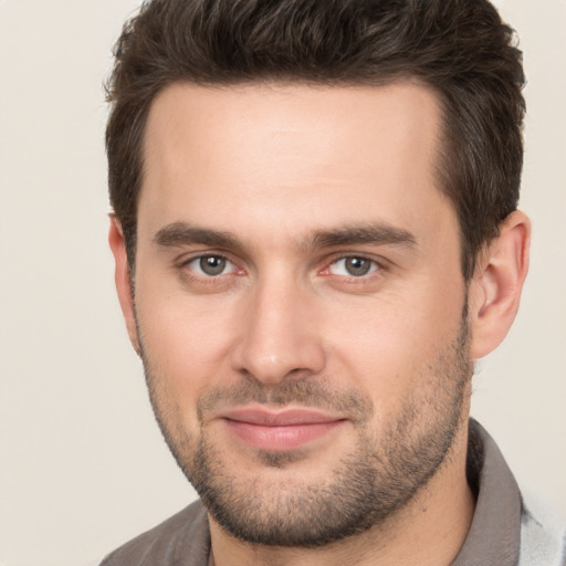 Joyful white young-adult male with short  brown hair and brown eyes