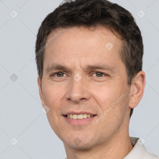 Joyful white adult male with short  brown hair and brown eyes