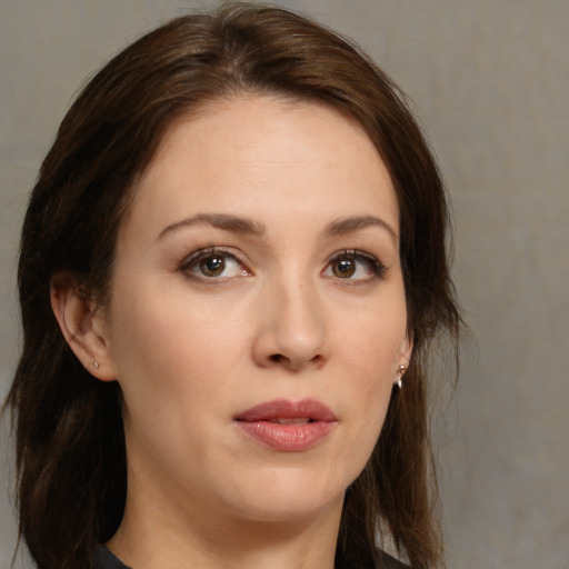 Joyful white young-adult female with long  brown hair and brown eyes