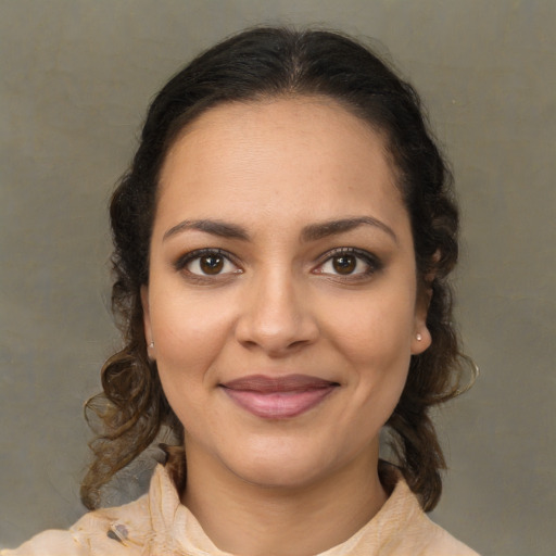 Joyful latino young-adult female with medium  brown hair and brown eyes