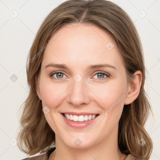 Joyful white young-adult female with medium  brown hair and blue eyes