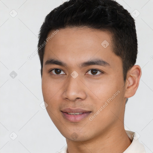 Joyful asian young-adult male with short  black hair and brown eyes