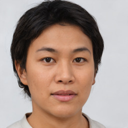 Joyful asian young-adult female with short  brown hair and brown eyes