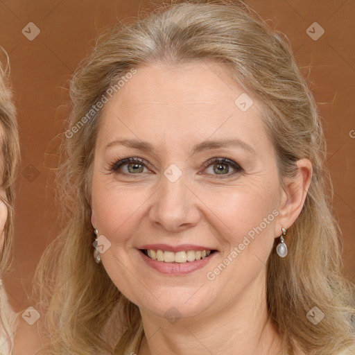 Joyful white adult female with long  brown hair and green eyes