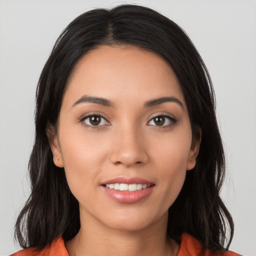 Joyful white young-adult female with long  brown hair and brown eyes