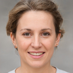 Joyful white adult female with short  brown hair and grey eyes