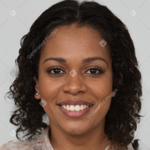 Joyful black young-adult female with medium  brown hair and brown eyes