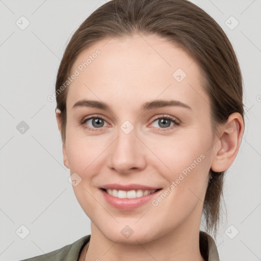 Joyful white young-adult female with long  brown hair and grey eyes