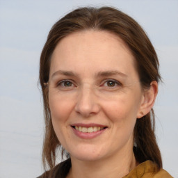 Joyful white adult female with medium  brown hair and brown eyes