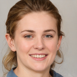 Joyful white young-adult female with medium  brown hair and blue eyes