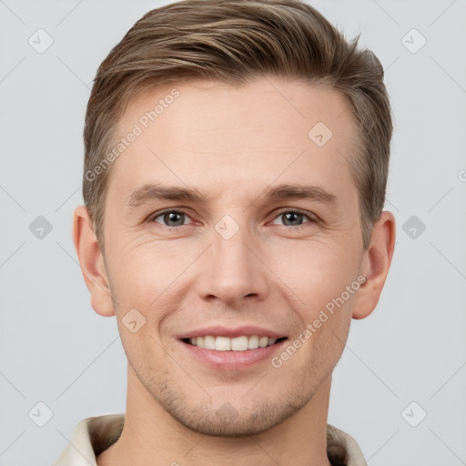 Joyful white young-adult male with short  brown hair and grey eyes