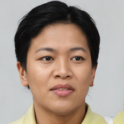 Joyful asian young-adult female with short  brown hair and brown eyes