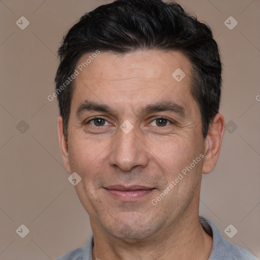 Joyful white adult male with short  black hair and brown eyes